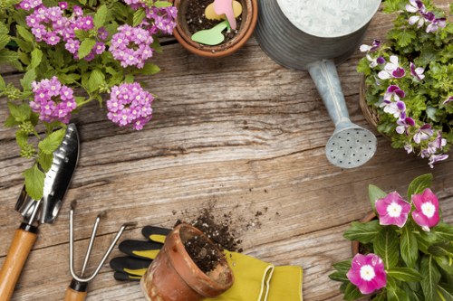 Gardener preparing tools for hedge trimming in Harrow