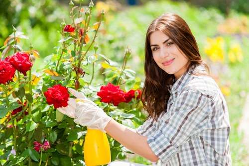 Garden maintenance crew using mulch and pruning tools